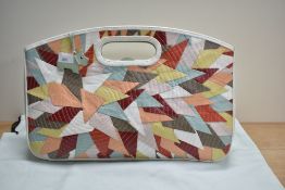 A Radley leather hand bag having a stitched geometric and multi-coloured design, measuring 35cm