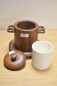 A 1930s wooden tobacco jar, having integrated pipe holders to sides and ceramic liner.