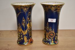 A pair of Art Deco Carlton Ware blue lustre vases with flared rims, enamelled in a Persian style
