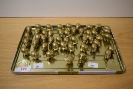 Approximately forty five small brass Chinese lucky pigs, a small brass bull and a small brass dog.