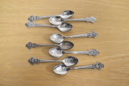 A set of eight white metal Rolex spoons, having the Rolex logo to the terminals, names of cities
