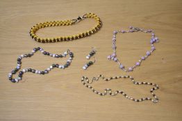 A collection of beaded and pearl jewellery, comprising a yellow and black beaded necklace, a peach