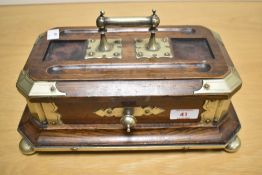 A late 19th Century oak desk stand, having white metal mounts, carrying handle and drawer, all