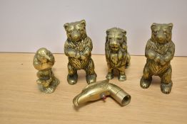 Three brass money boxes, two in the form of bears the other as a lion, as well as a bird paperweight