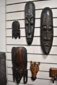 A selection of African hardwood carved masks, of varying sizes, possibly of Kenyan origin, and