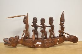An oriental carved and inlaid boat, depicted with rowing figures aboard.