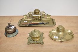 A 19th Century brass desk stand with glass inkwell, measuring 25cm long, an Art Nouveau brass desk