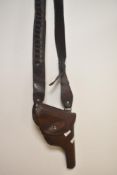 An early 20th Century brown leather gun holster and ammunition belt