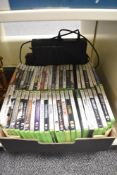An Xbox 360 console with two controllers with an assortment of games including Modern Warfare 2,