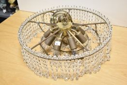 A vintage eight bulb glass light fitting having beaded droplets.