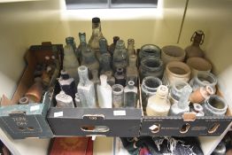 A large selection of vintage stoneware jars and dumpfind bottles.