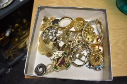 An assortment of costume jewellery, including various brooches of different size and design, a
