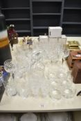 An assortment of cut glass drinking glasses including high ball, desert wine glasses, large sherry