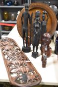 An African hardwood carved wall plaque, of bowed form, decorated with animals including a lion,
