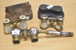 Three sets of late 19th Century Mother of Pearl and brass opera glasses with two cases