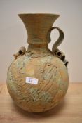 A studio pottery vase, having rustic finish, of bulbous form with handle to side, approx 36cm high.