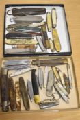 A selection of various vintage pocket knives, varying in size and design, some with Mother-of-