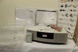 A Bose Wave Radio / CD in ivory colour with remote - appears to have never been used