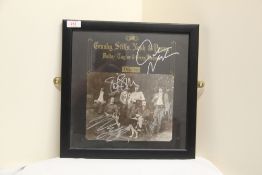 A signed and framed Crosby , Stills . Nash and Young ' Deja-Vu ' album sleeve - whilst we can't