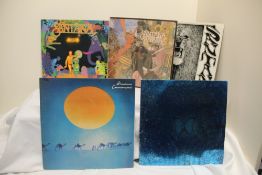A lot of thirteen Santana and related titles as in photos