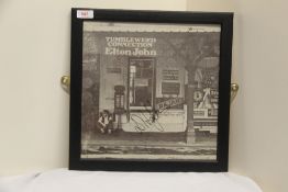 An Elton John ' Tumbleweed Connection ' album sleeve - signed and framed - whilst we can't verify