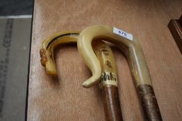 Two shepherds crooks one with a carved thistle 124cm approx