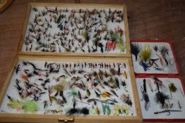 A large wooden box with an assortment of salmon and trout flies and a Leeda pocket box with similar