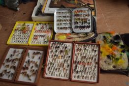 A nice selection of salmon and trout flies in 4 pocket boxes and 2 wallets