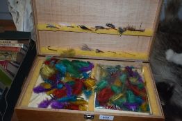 A three compartment wooden box containing Fly tying equipment with a selection of cotton selection
