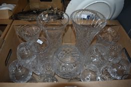 A collection of assorted cut glass including two large cut glass vases and three smaller similar,