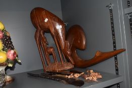 An African carved hardwood antelope and calf, measuring 45cm tall, another large carved wooden