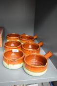 Six studio pottery soup dishes having brown and green glaze.