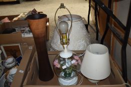A large wooden vase, two table lamps, one having a glass base with floral insert and two large