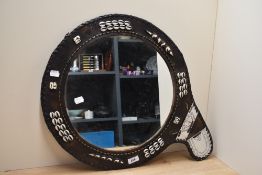 An African leather framed mirror, with shell decoration and beadwork.