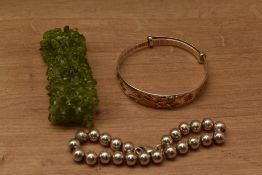 A selection of bracelets comprising a silver beaded example, a Chinese style expanding bracelet with