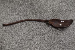A large African ethnic carved spoon or ladle, measuring 85cm long