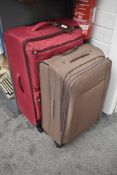 Two large soft touch suitcases with wheels and pull handles.
