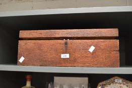 A vintage oak writing desk, in need of restoration, containing a selection of assorted celebration