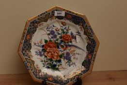 A mid-20th Century Japanese porcelain plate of octagonal form, decorated in polychrome with peonies,