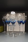 A boxed set of six ArtCrystal hand engraved by Patrick McMahon wine glasses having grapevine