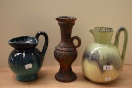 Three studio pottery jugs having decorative glazes.