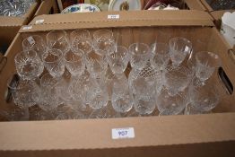 A carton of assorted cut glass wine and spirit glasses.