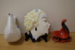 A mid-century Moorland wall mask, A Carlton ware hand painted pipe rest in red and black as well
