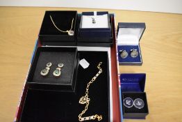 An assortment of boxed costume jewellery including paste set statement drop earrings, two pairs of