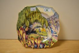 A brightly patterned transfer printed and hand coloured Art Deco design plate, having bridge and