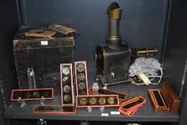 A Victorian 'Magic Lantern' slide projector and a selection of various children's coloured slides,
