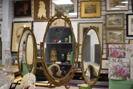 A Victorian style gilt metal triptic dressing table mirror.