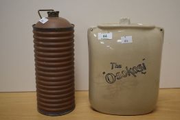 A ribbed copper hot water bottle, of ribbed cylindrical form with screw-off brass cover and
