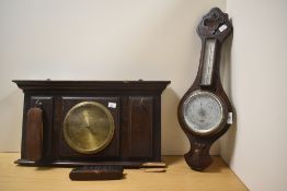 An Edwardian oak wall mounting barometer and combined brush stand, having some damage to the lower