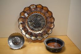 An iridescent Imperial Carnival glass dish with grape design to the centre, having a diameter of